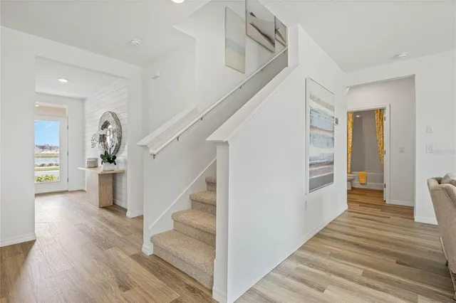 a view of entryway and hall with wooden floor