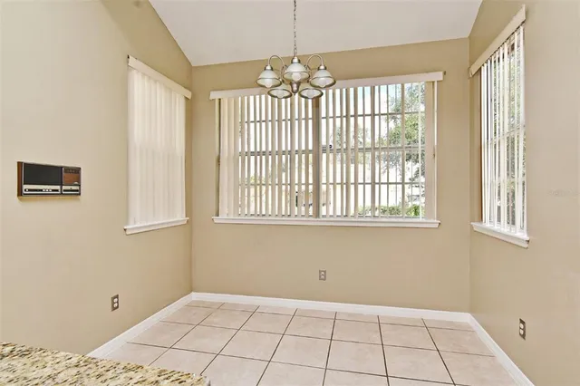 a kitchen with a refrigerator and a stove top oven