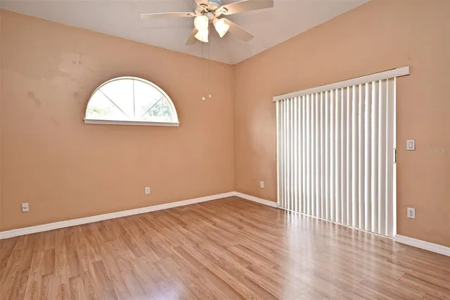 a view of an empty room with wooden floor