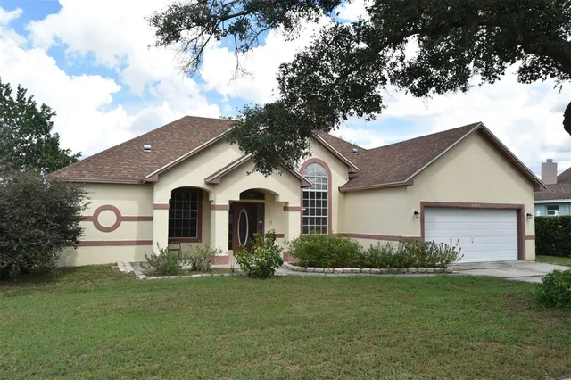 a front view of house with yard and green space