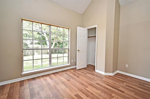a view of an empty room with wooden floor