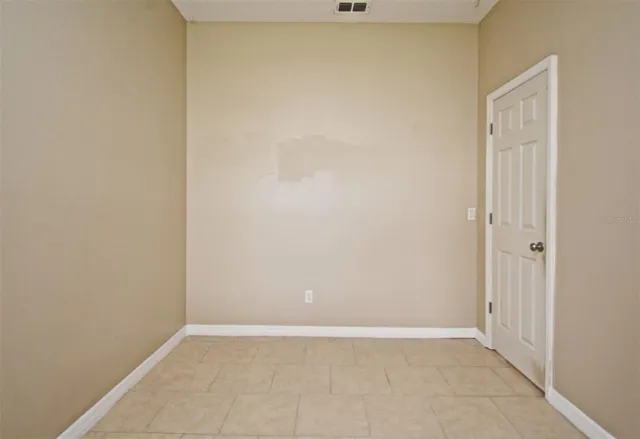 a view of an empty room with fire place and a fireplace