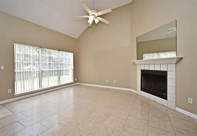 a living room with stainless steel appliances kitchen island a fireplace and a fireplace