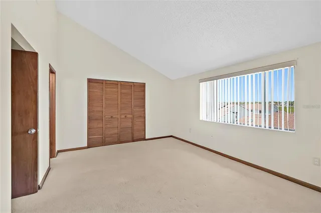 a bathroom with a granite countertop sink a toilet and a large mirror