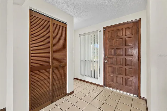 a view of a livingroom with a fireplace window and staircase