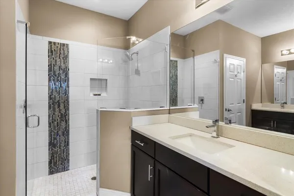 a bathroom with a double vanity sink and mirror