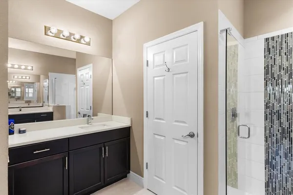 a bathroom with a shower and a sink
