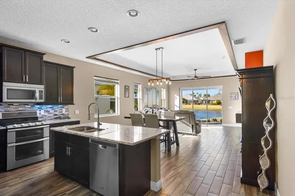 a kitchen with stainless steel appliances granite countertop a sink and a stove