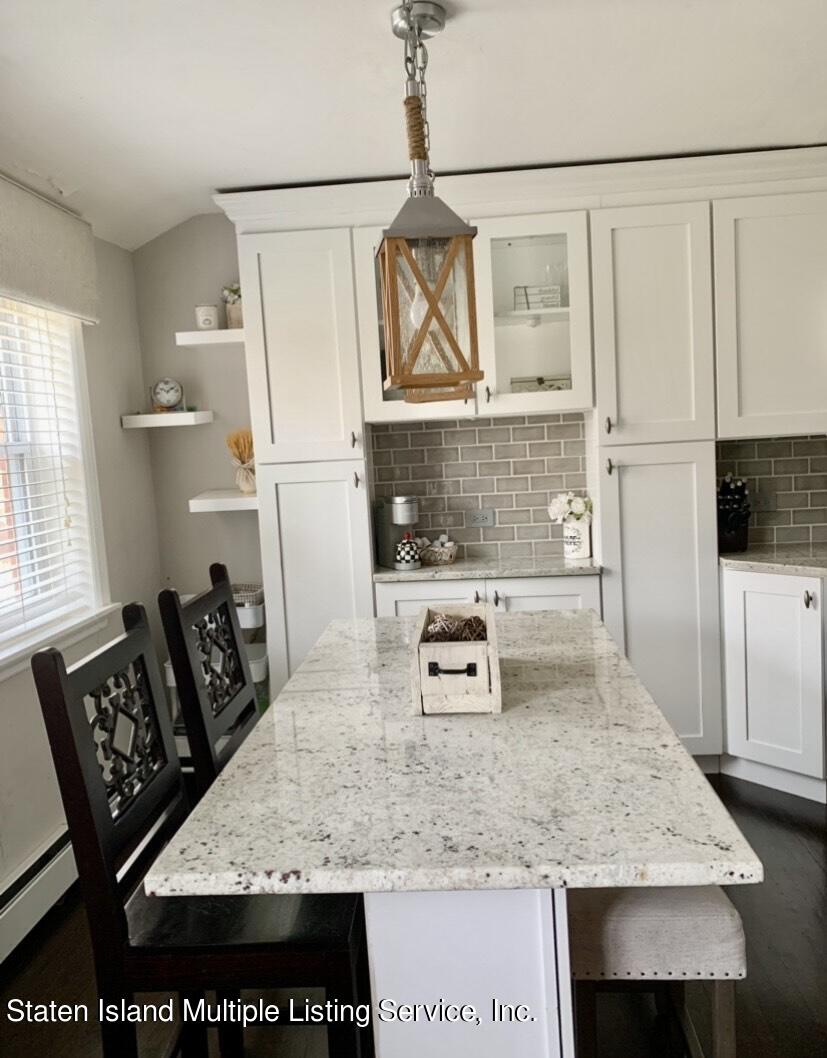 3482 Amboy Road, Unit 2A Staten Island, NY 10306 - Photo 5 of 15 a kitchen with stainless steel appliances granite countertop a sink refrigerator and stove