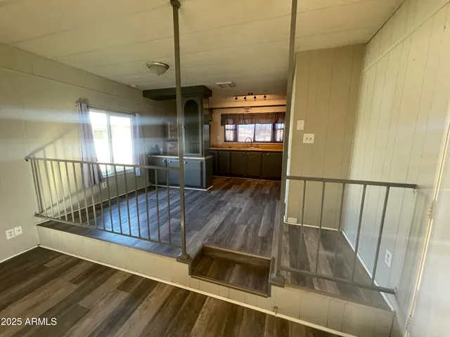 a kitchen with cabinets and wooden floor