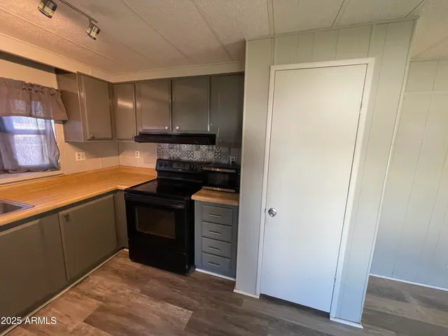 a kitchen with refrigerator and window