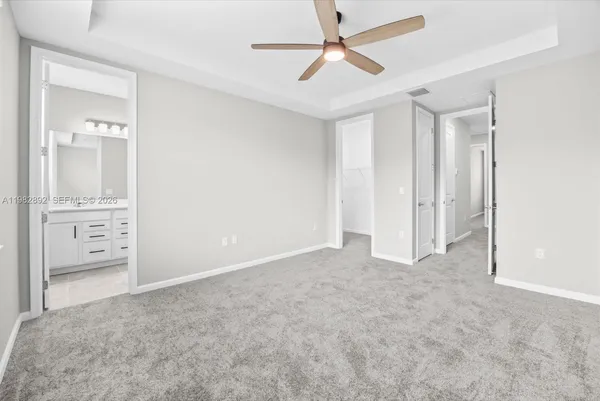 a bathroom with double vanity sink and shower