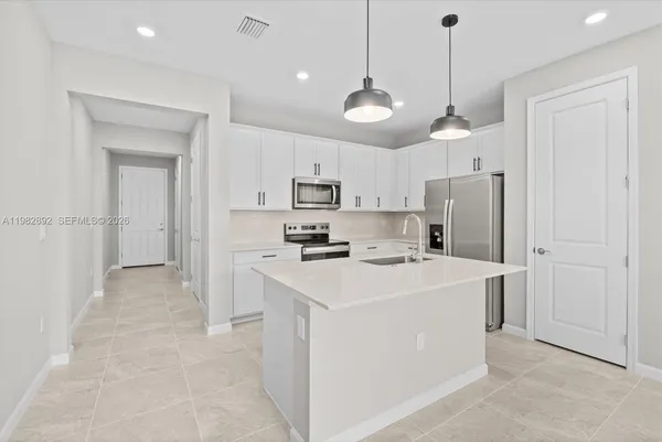 a view of a kitchen and stainless steel appliances