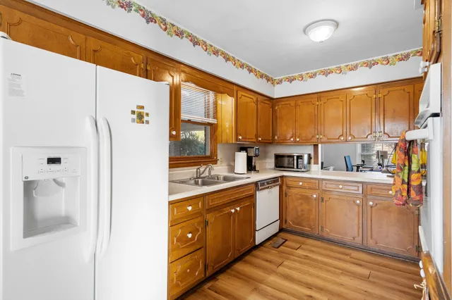 a kitchen with a sink a refrigerator and cabinets
