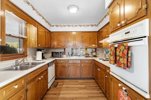 a large kitchen with stainless steel appliances granite countertop a sink and cabinets