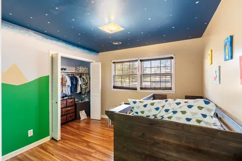 a bedroom with windows and bed