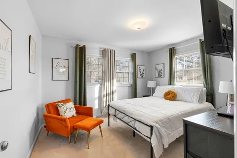 a bedroom with a bed and a flat screen tv