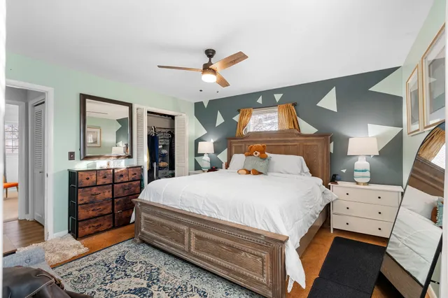 a bedroom with a bed and wooden floor