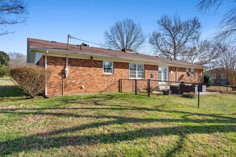 a front view of a house with a yard table and chairs