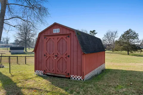 a view of a backyard with a tree