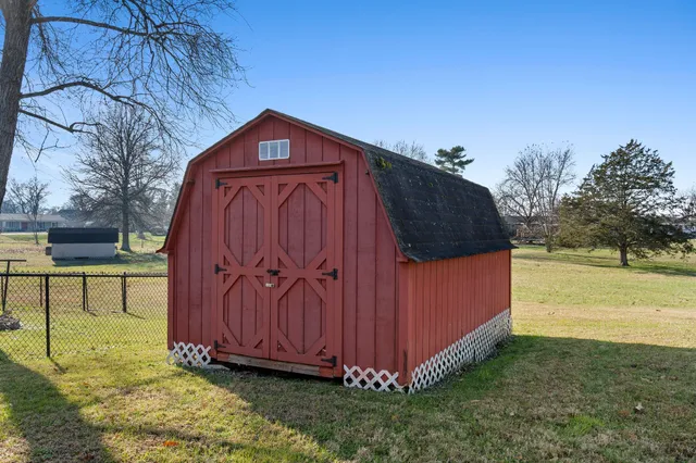 a view of a backyard with a tree