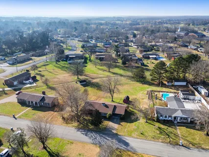 an aerial view of a house with a swimming pool