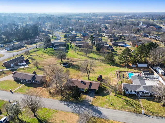 an aerial view of a house with a swimming pool