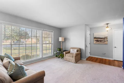 a living room with furniture and large windows