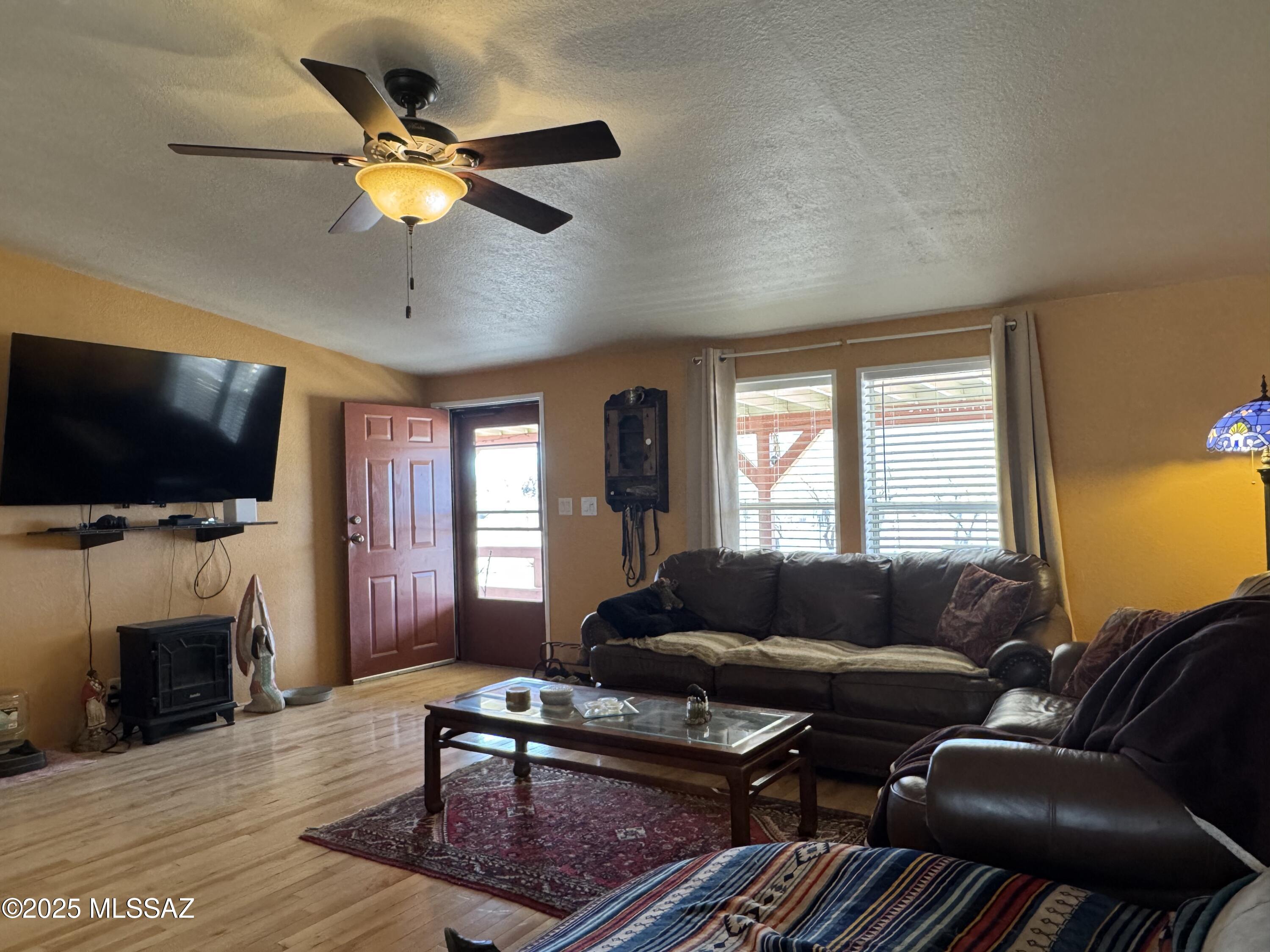 12440 South Coleman Road Tucson, AZ 85735 - Photo 18 of 45 a living room with furniture a flat screen tv and a fireplace