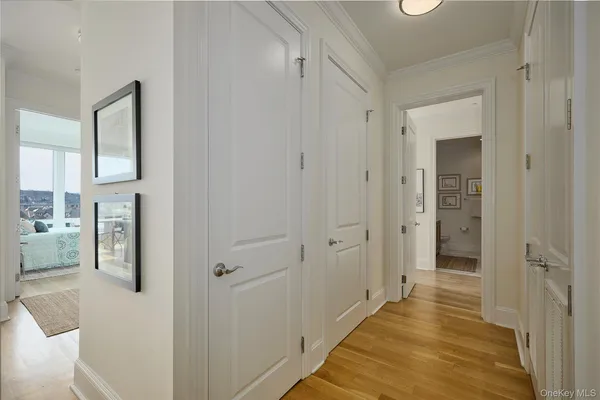 a view of a hallway with a cabinet and a bathroom
