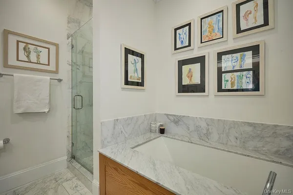 a bathroom with a granite countertop tub sink and mirror