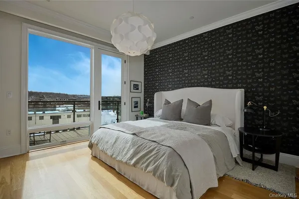a large bed sitting in a bedroom next to a window with kitchen view