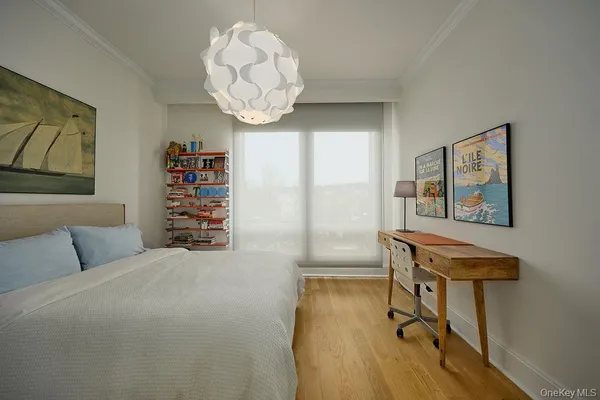 a bedroom with a bed and a chandelier