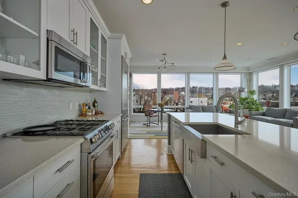 a kitchen with stainless steel appliances a sink a stove and cabinets