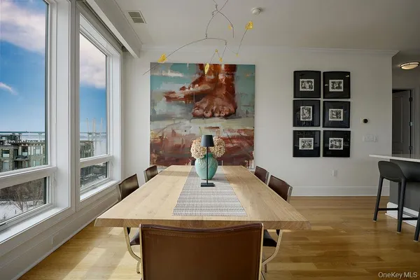 a dining room with furniture and wooden floor