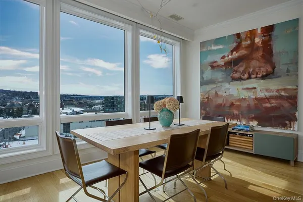 a view of a dining room with furniture window and wooden floor