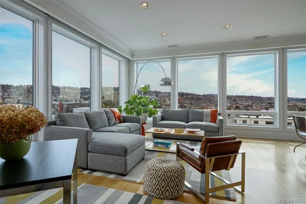 a living room with furniture and a floor to ceiling window