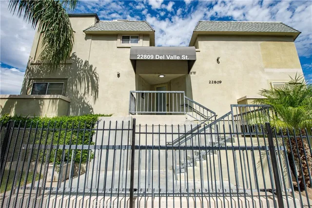 a view of a house with a iron gate