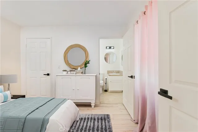 a bedroom with a bed and a mirror