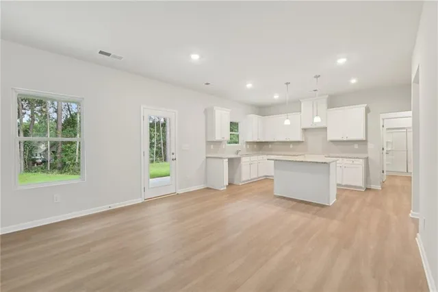 a view of kitchen with wooden floor and windows
