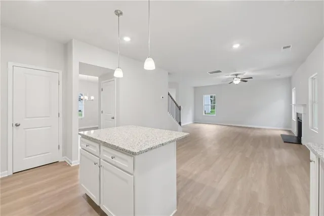 wooden floor in an empty room with a kitchen