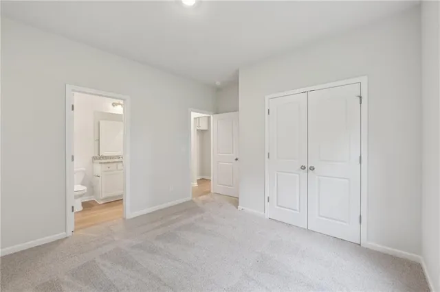 a view of an empty room and closet area