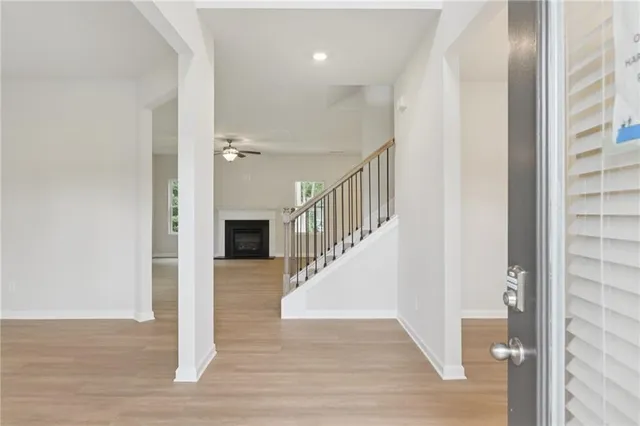 a view of entryway and hall with wooden floor