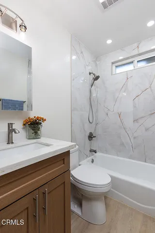 a bathroom with a sink a toilet and a bathtub