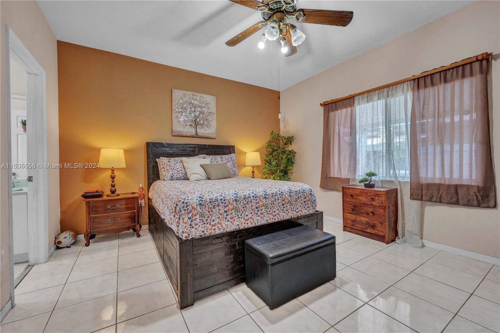 426 West 70th Street Hialeah, FL 33014 - Photo 13 of 26 a spacious bedroom with a large bed and a chandelier