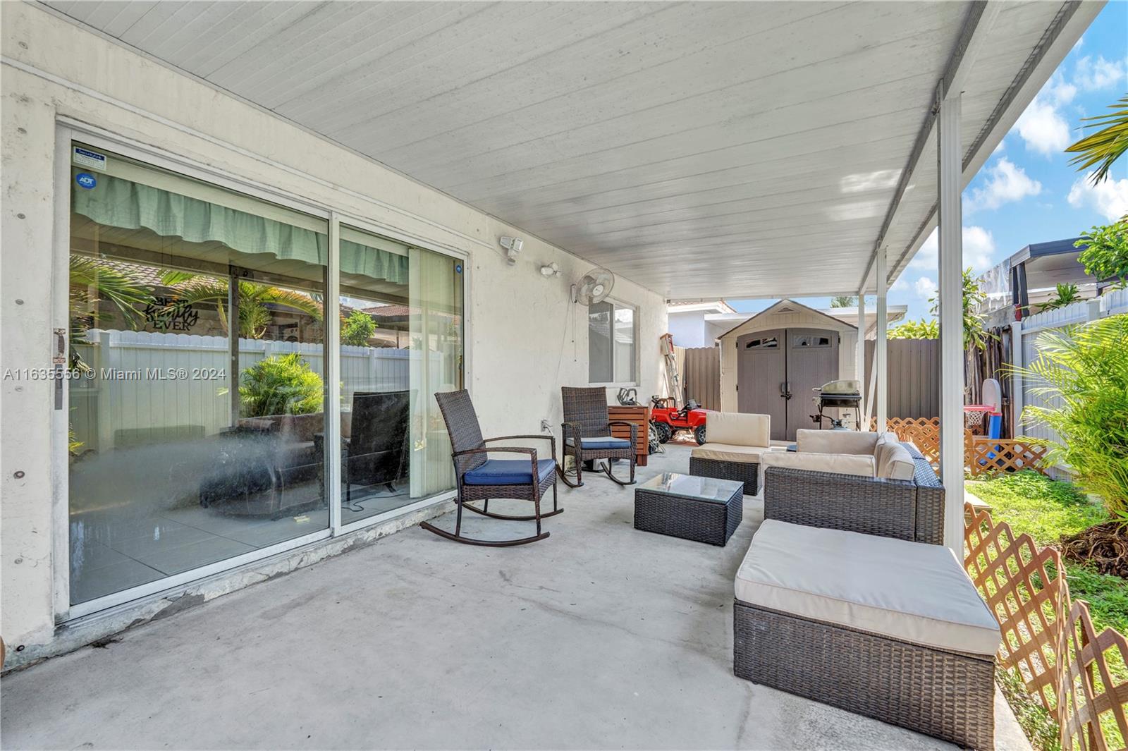426 West 70th Street Hialeah, FL 33014 - Photo 17 of 26 a living room with patio furniture and a potted plant