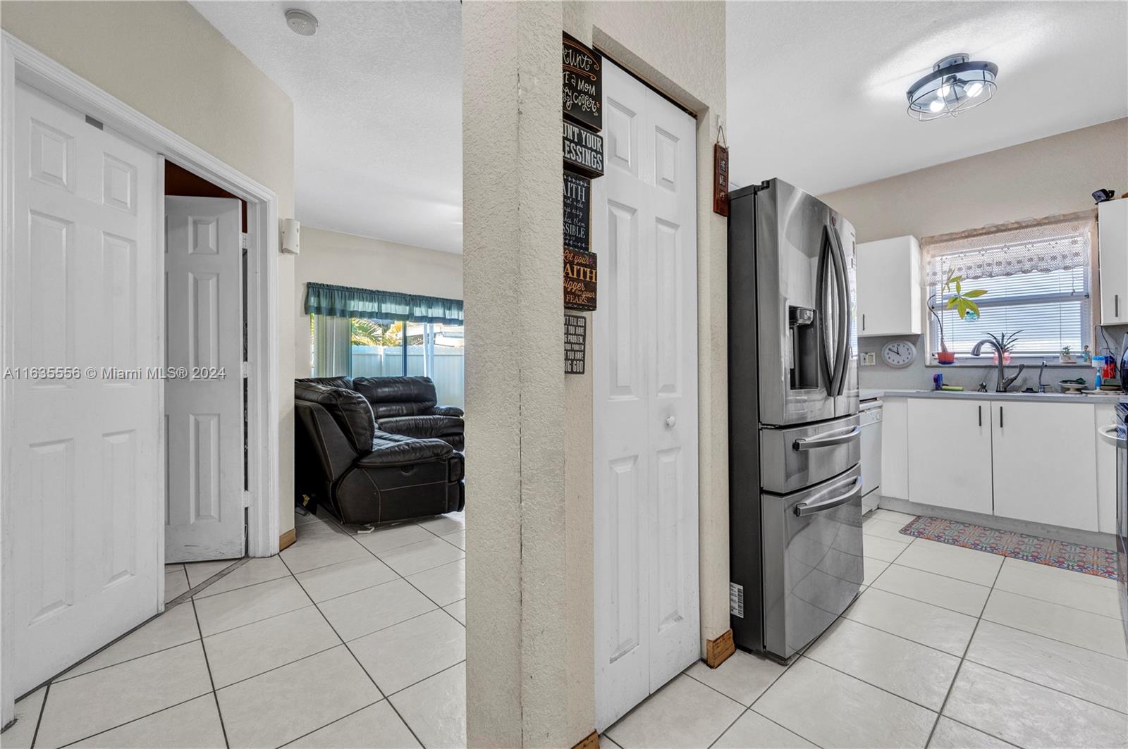 426 West 70th Street Hialeah, FL 33014 - Photo 19 of 26 a kitchen with a refrigerator and cabinets