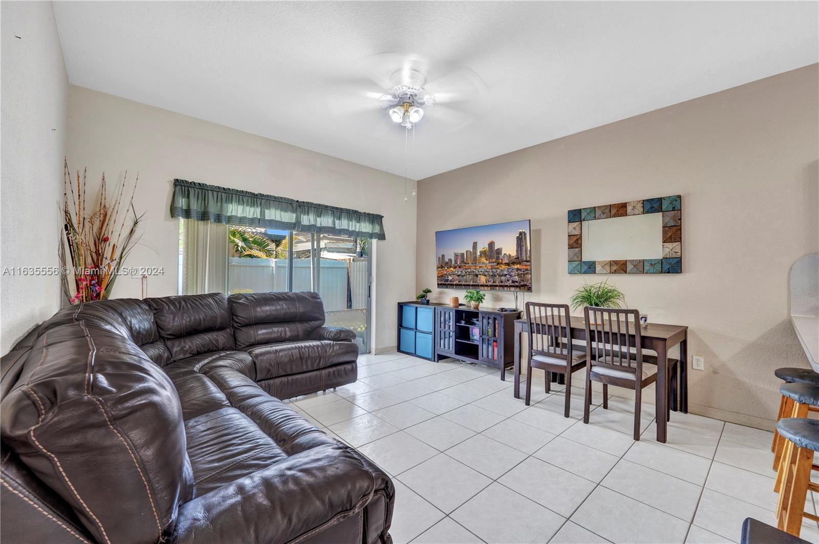 426 West 70th Street Hialeah, FL 33014 - Photo 7 of 26 a living room with furniture and a large window