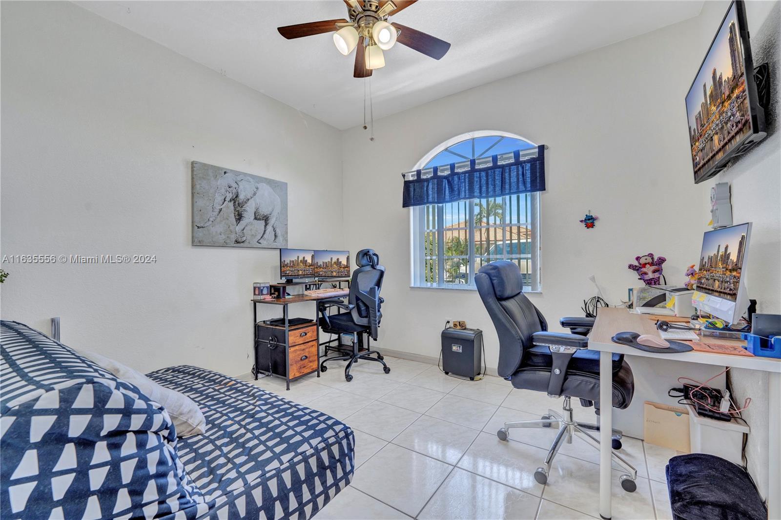 426 West 70th Street Hialeah, FL 33014 - Photo 10 of 26 a bedroom with bed and a chandelier