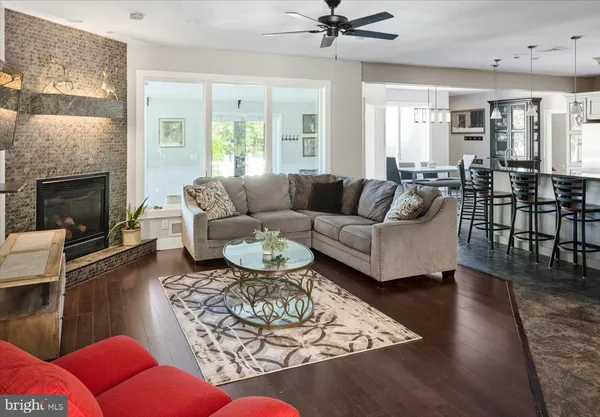 a living room with furniture a fireplace and a table